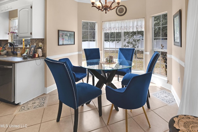 dining room featuring light tile patterned flooring, a chandelier, and sink