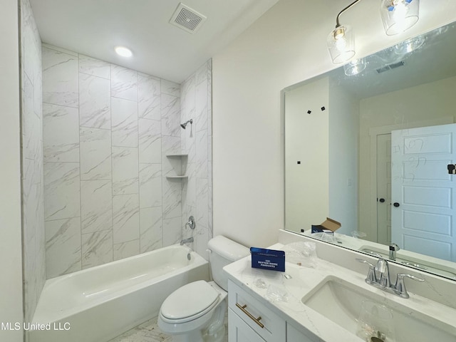 full bathroom featuring vanity, tiled shower / bath combo, and toilet