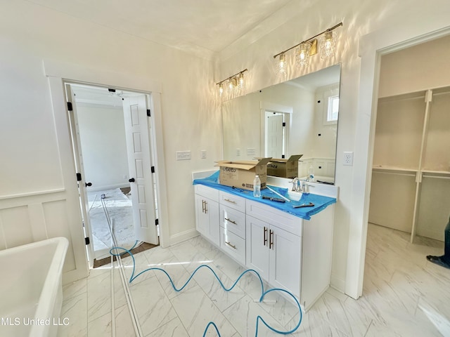 bathroom featuring vanity and a tub