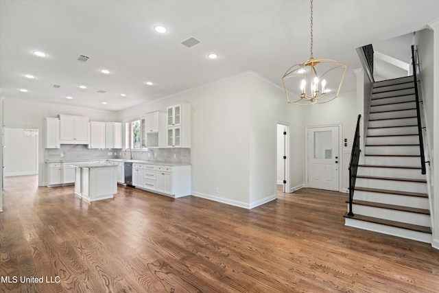 1594 Victoria Rd, Byhalia, MS 38611 - kitchen with dishwasher, ornamental molding, a kitchen island, a chandelier, and white cabinetry