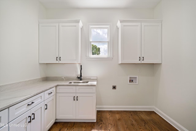 1594 Victoria Rd, Byhalia, MS 38611 - laundry area with washer hookup, electric dryer hookup, dark wood-style floors, baseboards, and cabinet space