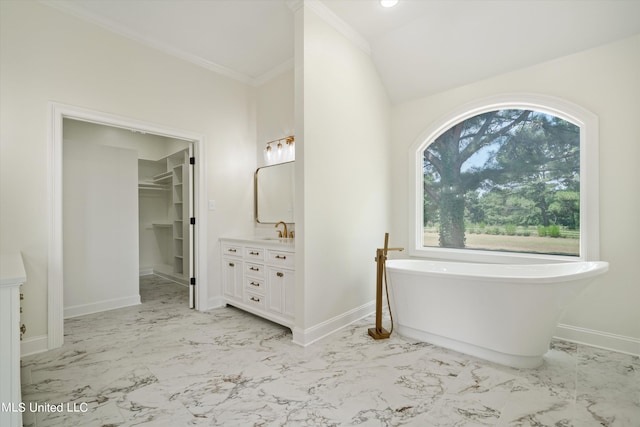 1594 Victoria Rd, Byhalia, MS 38611 - full bath featuring marble look tiles, a soaking tub, vanity, baseboards, and a spacious closet