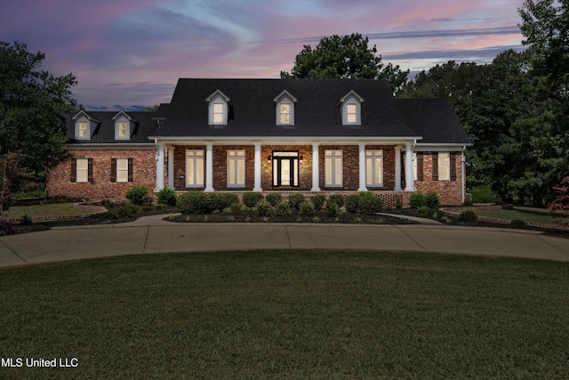 1594 Victoria Rd, Byhalia, MS 38611 - new england style home with brick siding, a front yard, and covered porch
