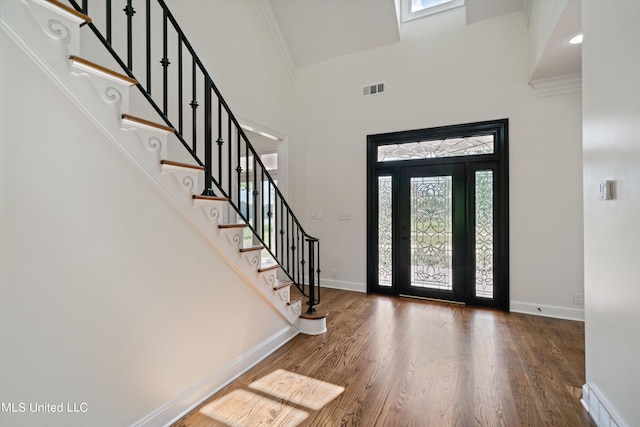 1594 Victoria Rd, Byhalia, MS 38611 - foyer with baseboards, wood finished floors, a towering ceiling, stairs, and crown molding