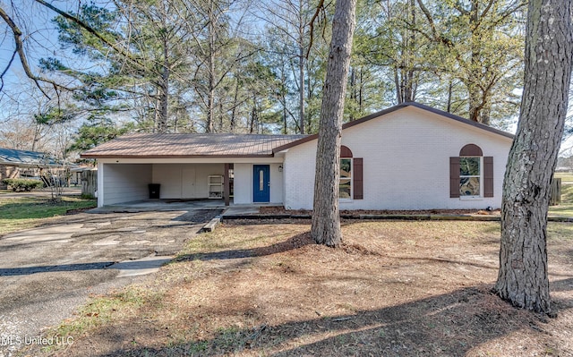 ranch-style house featuring a carport