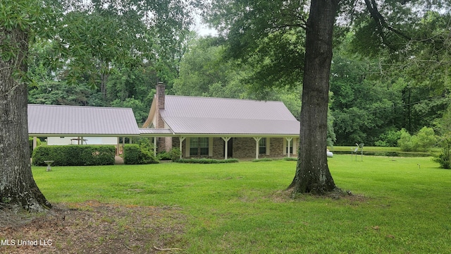 2257 Boyd Rd, Utica, MS 39175 - view of front facade with a chimney, a front yard, and metal roof