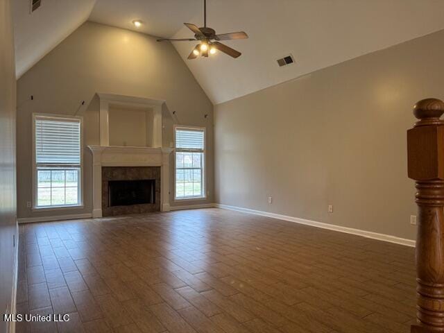 unfurnished living room with dark wood-style floors, visible vents, and a ceiling fan