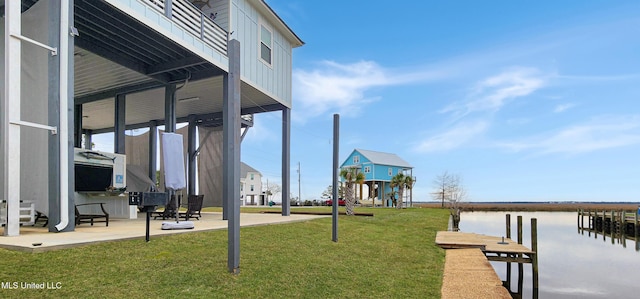 view of dock featuring a water view, playground community, a patio, and a lawn