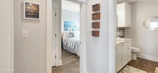 hall with dark wood finished floors and baseboards