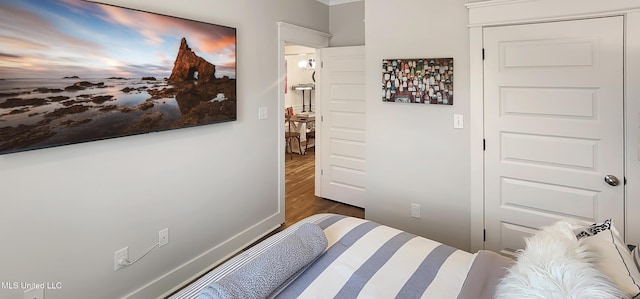 bedroom featuring dark wood-style floors and baseboards