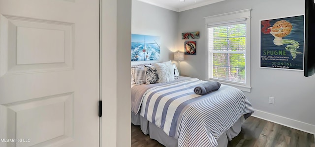 bedroom with baseboards, dark wood-style flooring, and ornamental molding