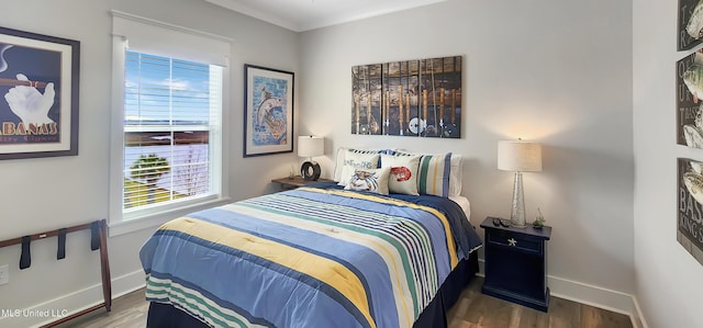 bedroom featuring dark wood-type flooring and baseboards