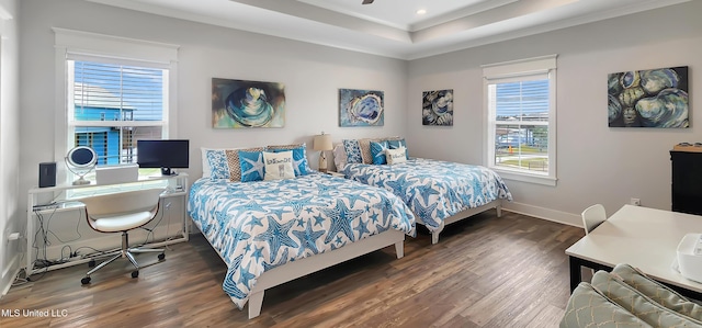 bedroom featuring crown molding, a raised ceiling, dark wood finished floors, and baseboards