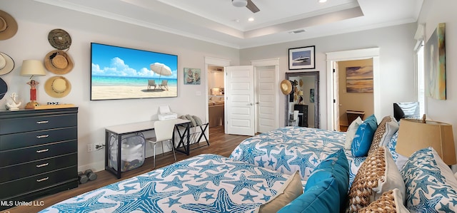 bedroom featuring visible vents, a raised ceiling, dark wood-style floors, crown molding, and recessed lighting