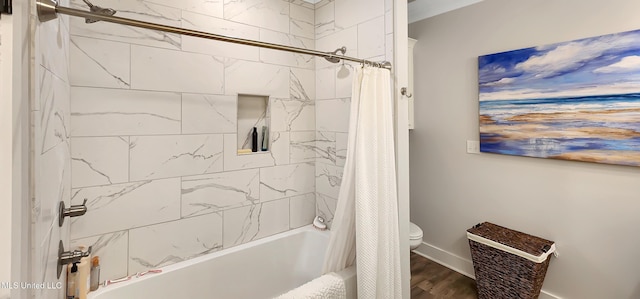 bathroom featuring toilet, shower / bath combination with curtain, and wood finished floors