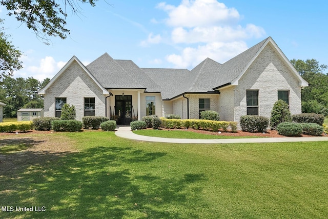 111 Jefferson Davis Pkwy, Picayune, MS 39466 - french country home with a front lawn, brick siding, and a shingled roof