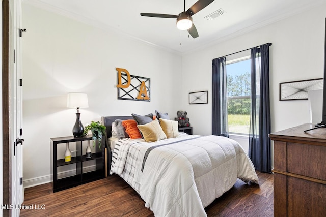 111 Jefferson Davis Pkwy, Picayune, MS 39466 - bedroom with dark wood finished floors, ornamental molding, ceiling fan, and baseboards