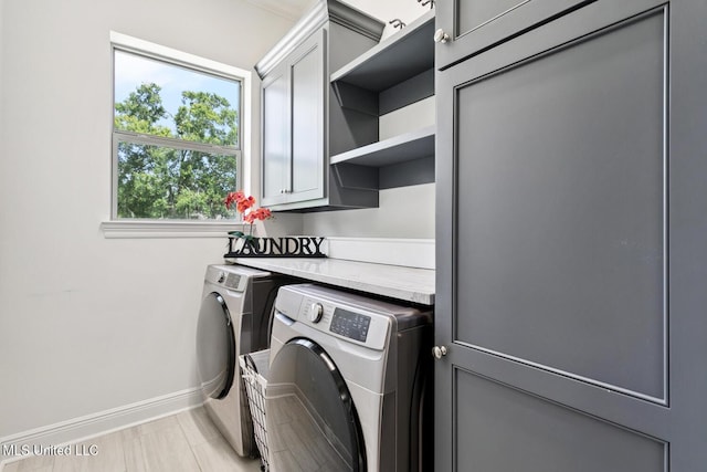 111 Jefferson Davis Pkwy, Picayune, MS 39466 - laundry area featuring cabinet space, baseboards, and separate washer and dryer