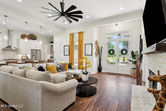 111 Jefferson Davis Pkwy, Picayune, MS 39466 - living area featuring a ceiling fan, crown molding, dark wood-style flooring, baseboards, and a fireplace