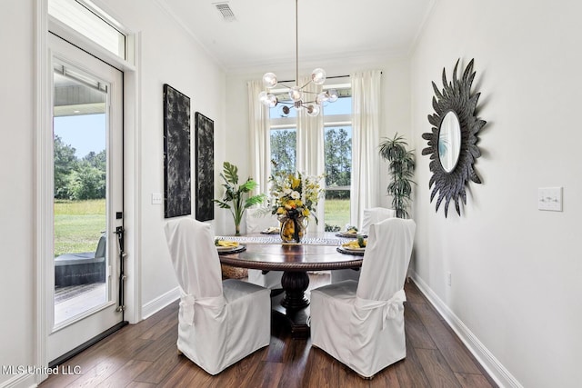 111 Jefferson Davis Pkwy, Picayune, MS 39466 - dining area with crown molding, healthy amount of natural light, dark wood-style flooring, a chandelier, and baseboards