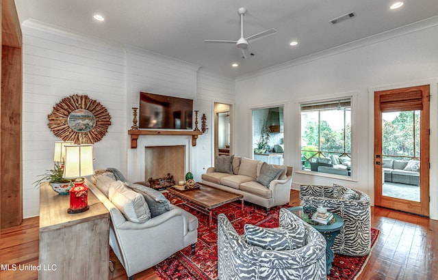 living room with crown molding, hardwood / wood-style flooring, and ceiling fan