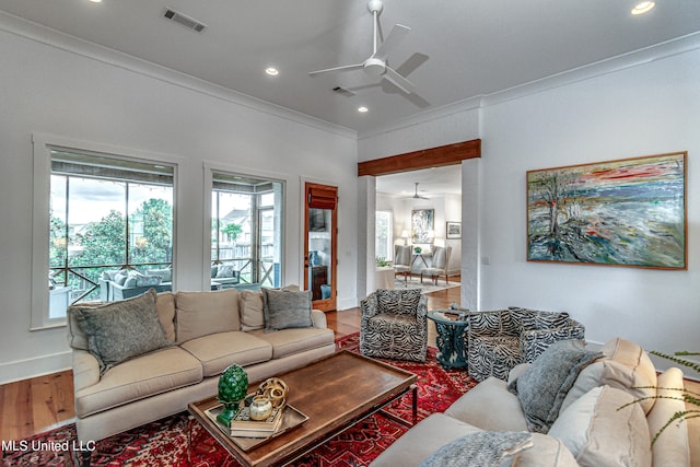 living room featuring ornamental molding, hardwood / wood-style floors, and ceiling fan