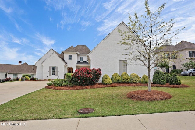 french provincial home with a front lawn