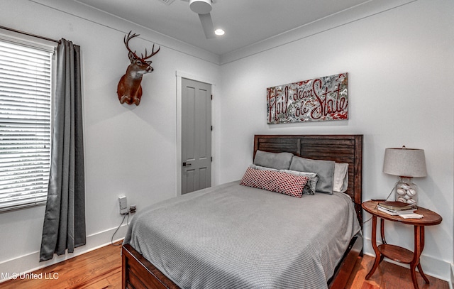 bedroom featuring hardwood / wood-style floors and ceiling fan