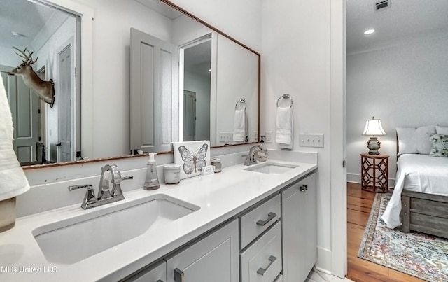 bathroom with vanity and hardwood / wood-style floors