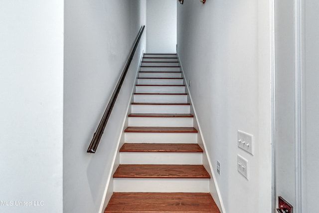 stairway featuring wood-type flooring