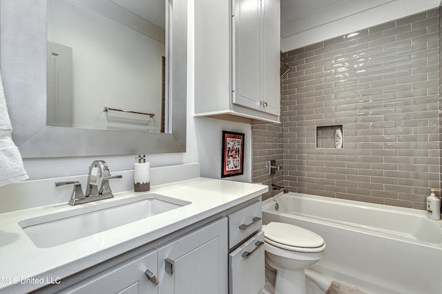 full bathroom featuring vanity, toilet, and tiled shower / bath combo