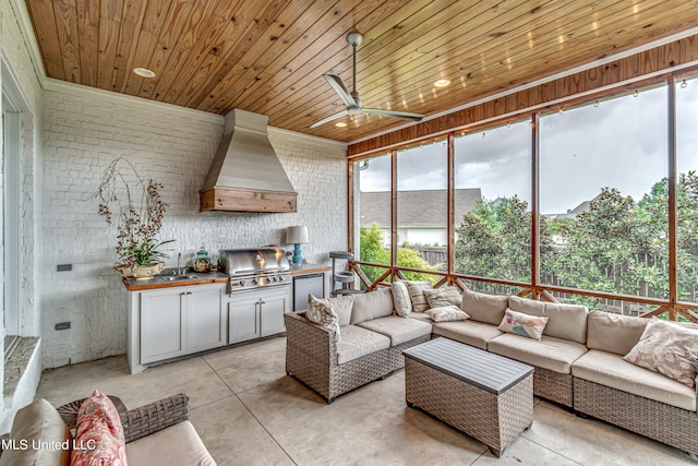 living room featuring ceiling fan, brick wall, wooden ceiling, and sink