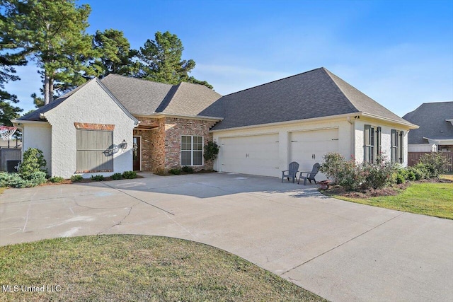 view of front of house with a shingled roof, brick siding, driveway, and an attached garage