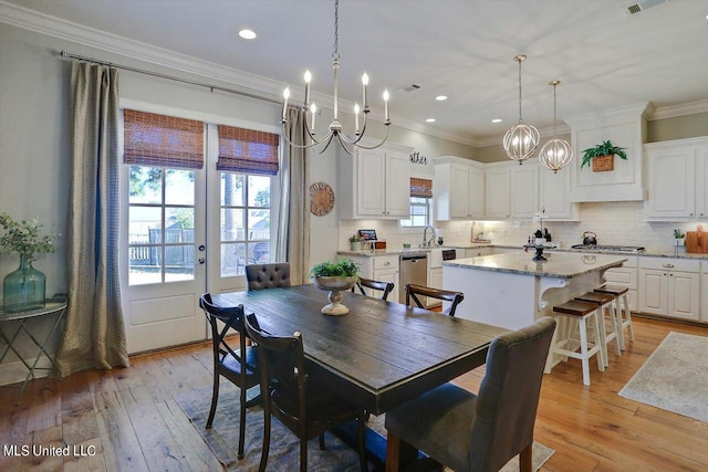 dining room with recessed lighting, french doors, crown molding, and light wood-style flooring