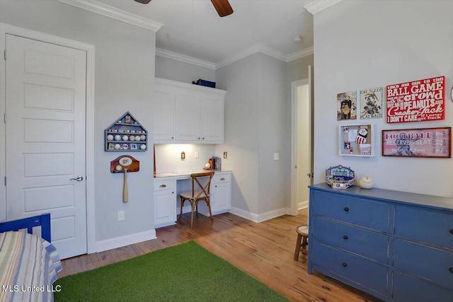 bedroom featuring baseboards, ornamental molding, built in desk, and wood finished floors