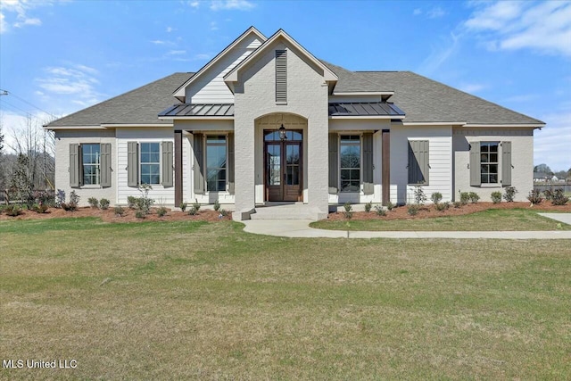 view of front of home featuring a standing seam roof, metal roof, and a front lawn