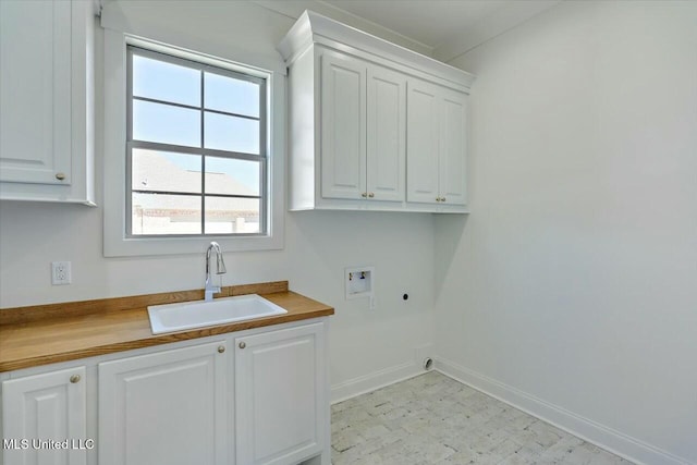 laundry area with light floors, hookup for a washing machine, cabinet space, hookup for an electric dryer, and a sink