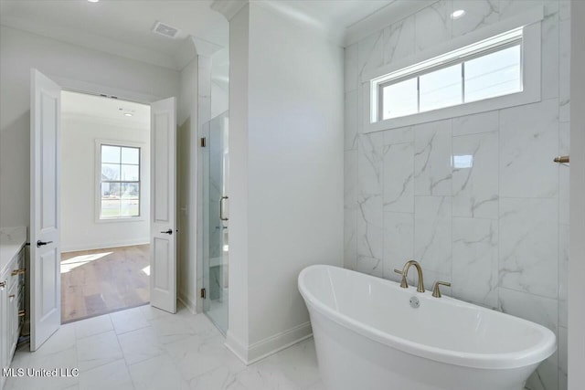 full bath featuring a wealth of natural light, marble finish floor, visible vents, and a freestanding bath