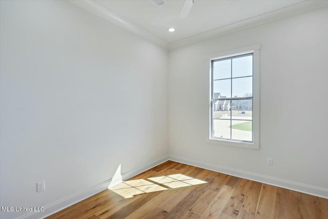 unfurnished room featuring baseboards and light wood finished floors