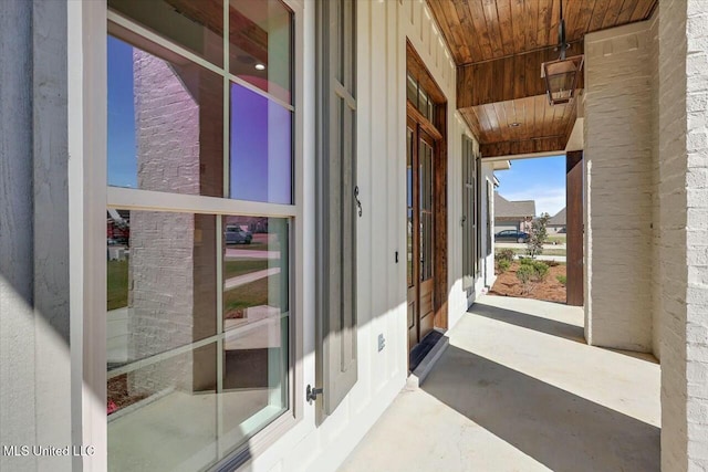 exterior space with wood ceiling and concrete floors