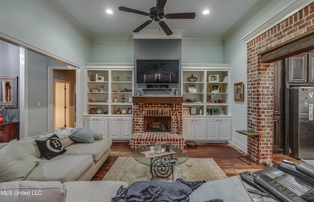 living room featuring dark wood-type flooring, ornamental molding, and a brick fireplace