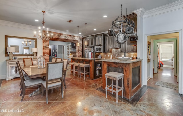 tiled dining space featuring ornamental molding