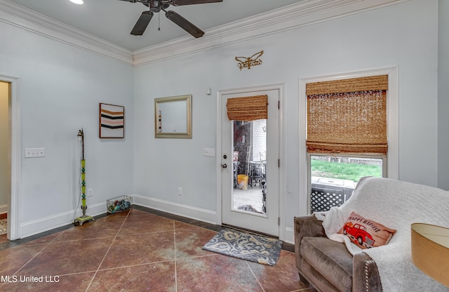 entryway featuring ceiling fan, ornamental molding, dark tile patterned flooring, and a wealth of natural light