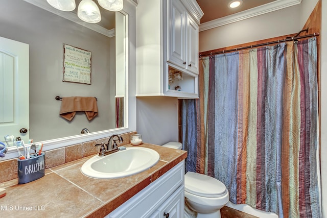 bathroom featuring vanity, crown molding, and toilet