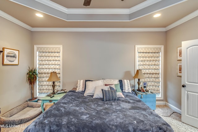 bedroom with crown molding, light carpet, ceiling fan, and a tray ceiling