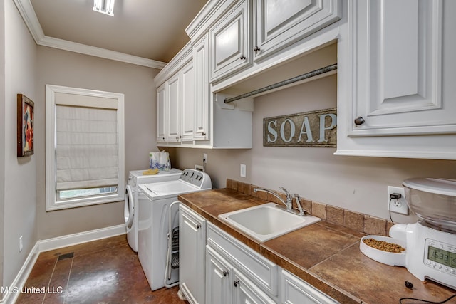 laundry area with cabinets, independent washer and dryer, ornamental molding, and sink