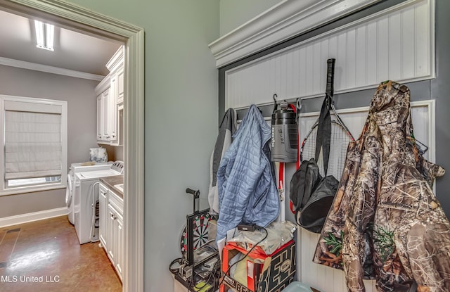 interior space with ornamental molding and washer and dryer