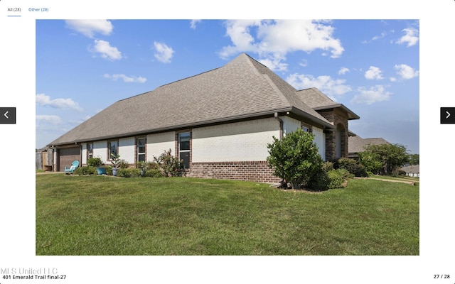 view of home's exterior with a garage and a yard