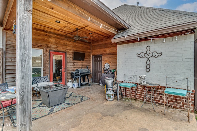 view of patio with area for grilling and ceiling fan