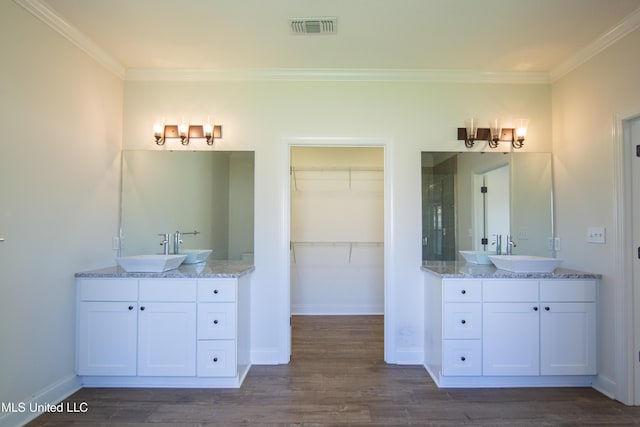 163 Frye Cir, Caledonia, MS 39740 - full bathroom with two vanities, a shower stall, wood finished floors, crown molding, and a walk in closet